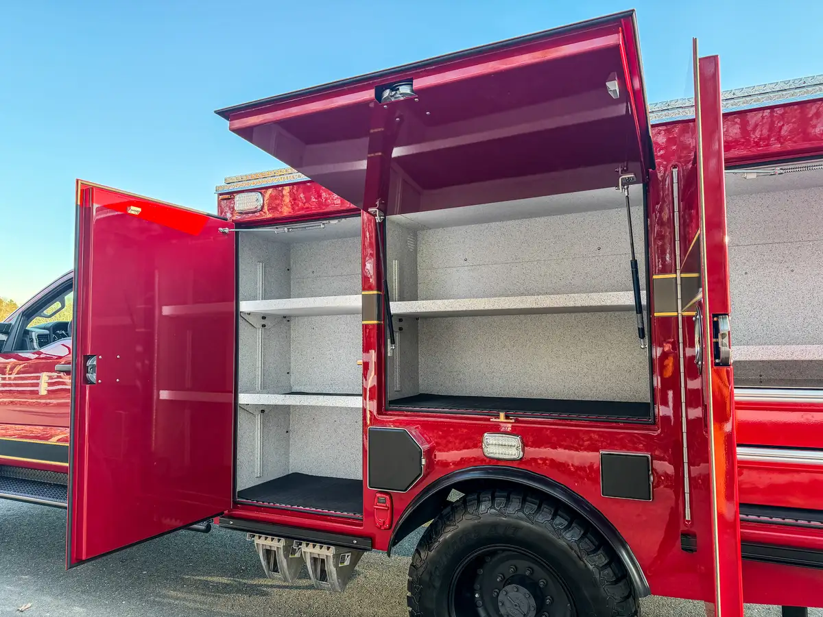 Wide side view of open compartments with top hatch raised.