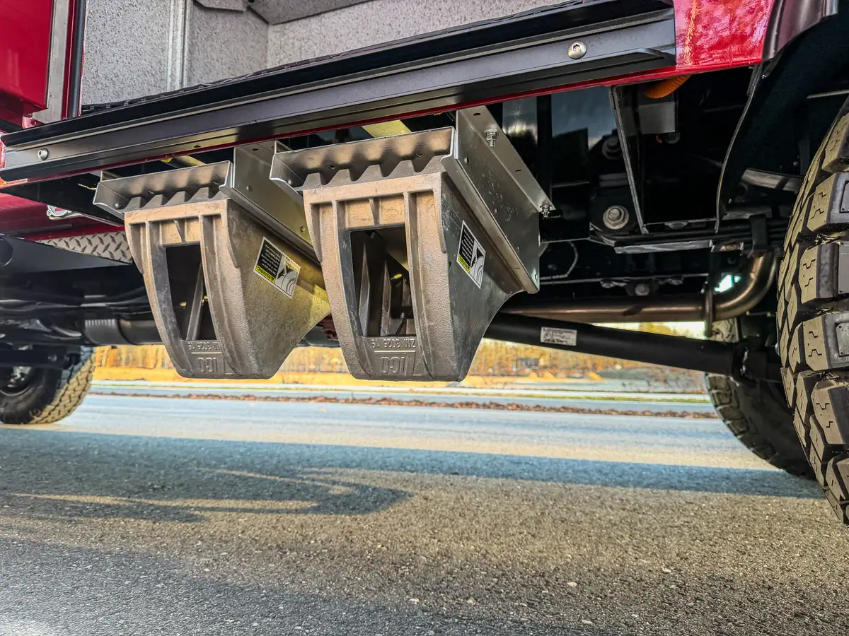 Underbody drop-down steps mounted below side compartments.