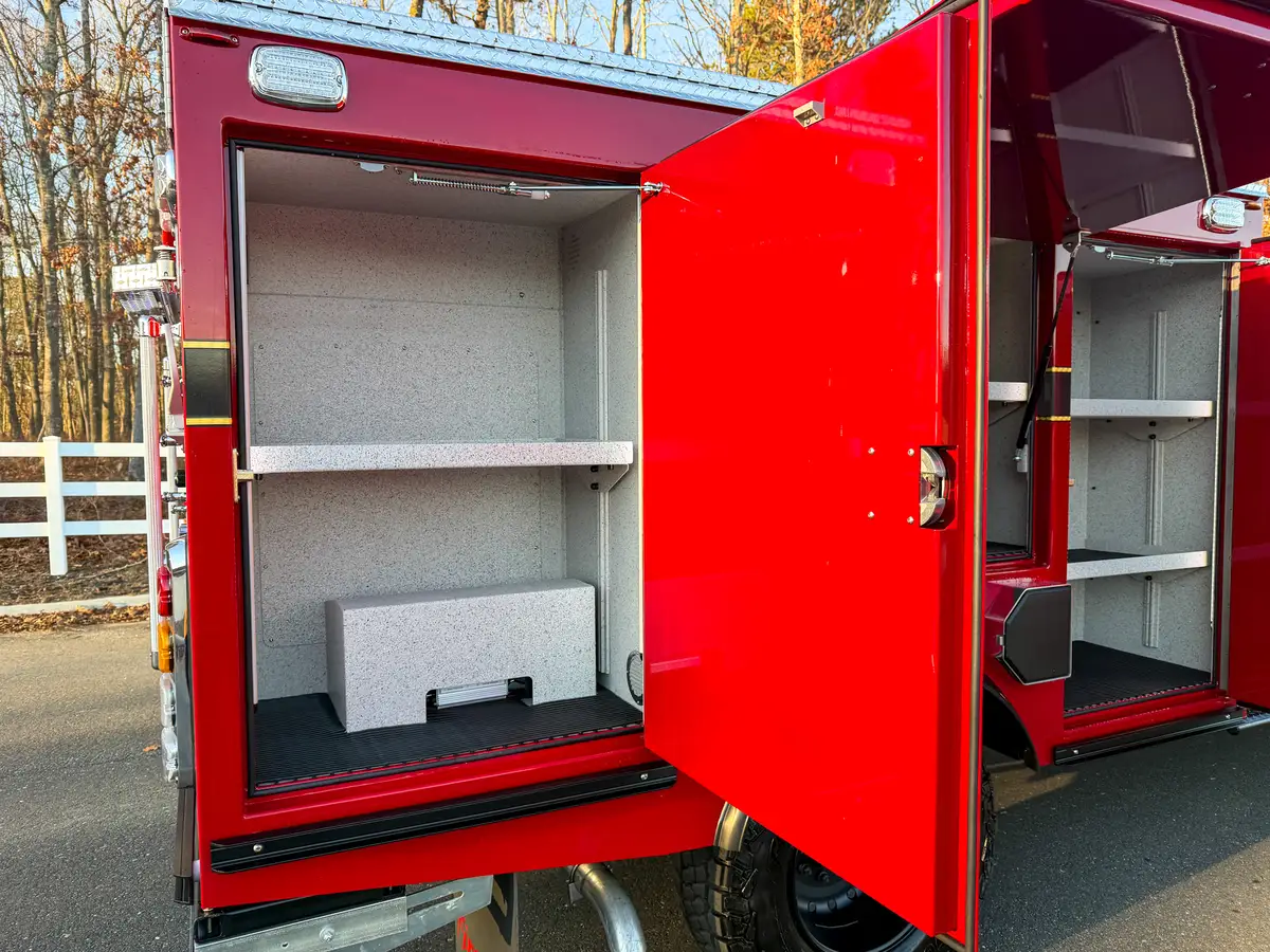 Close-up of rear left compartment with shelf and lower storage block.