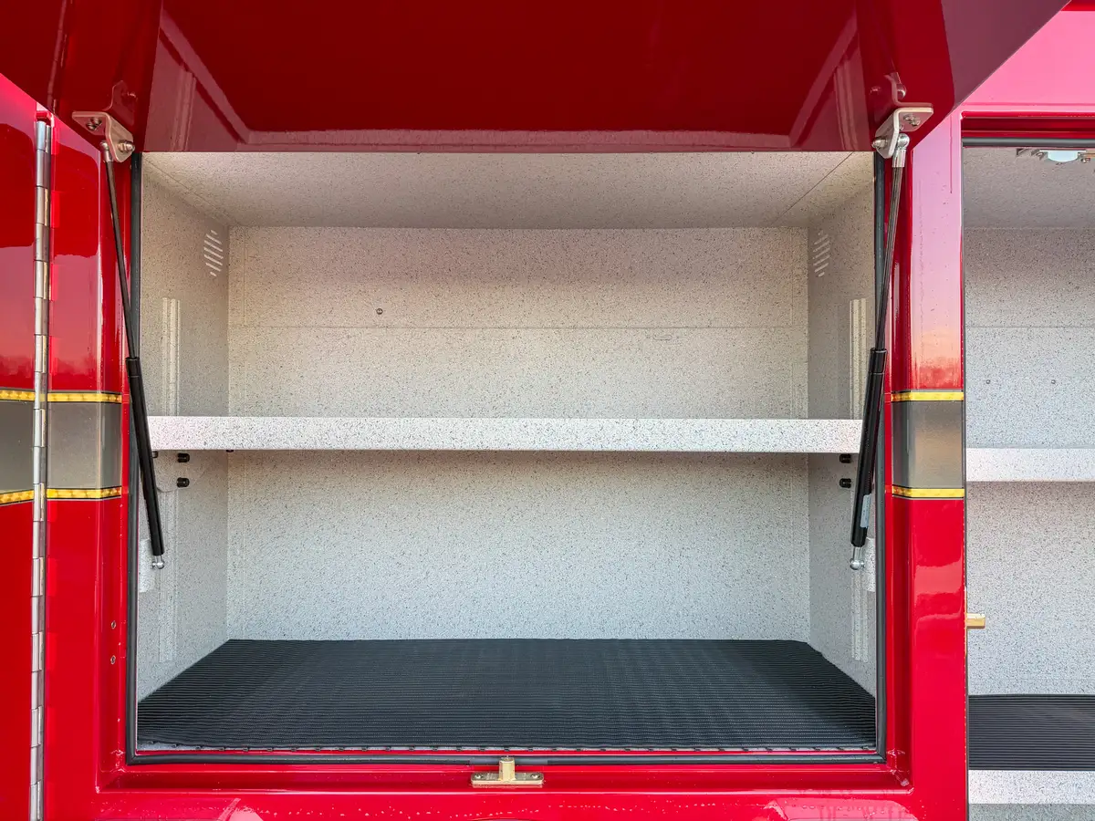 Close-up of center left compartment with single shelf and open hatch.