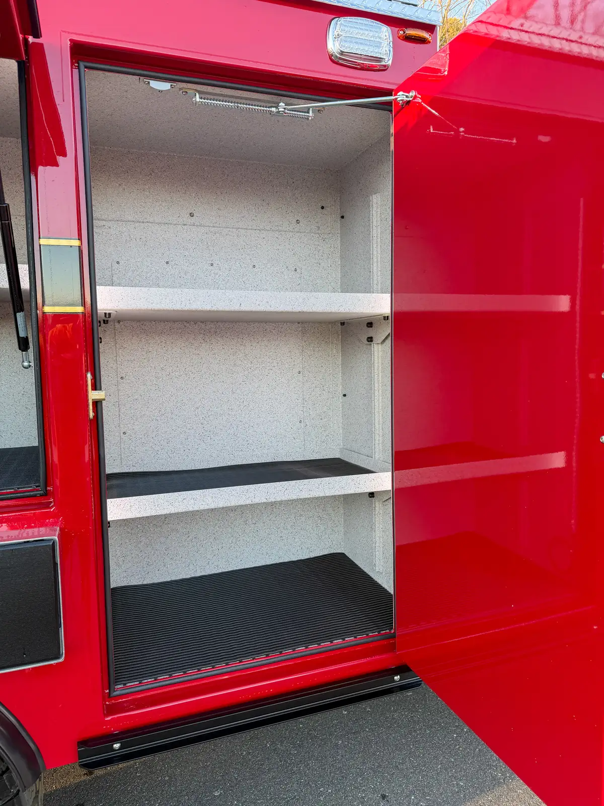 Close-up of front left vertical compartment with three interior shelves.