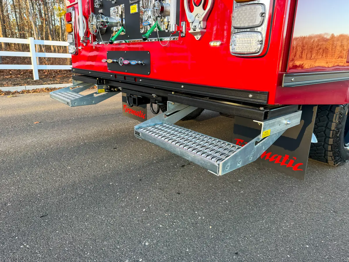 Rear view with both slide-out steps deployed on each side.