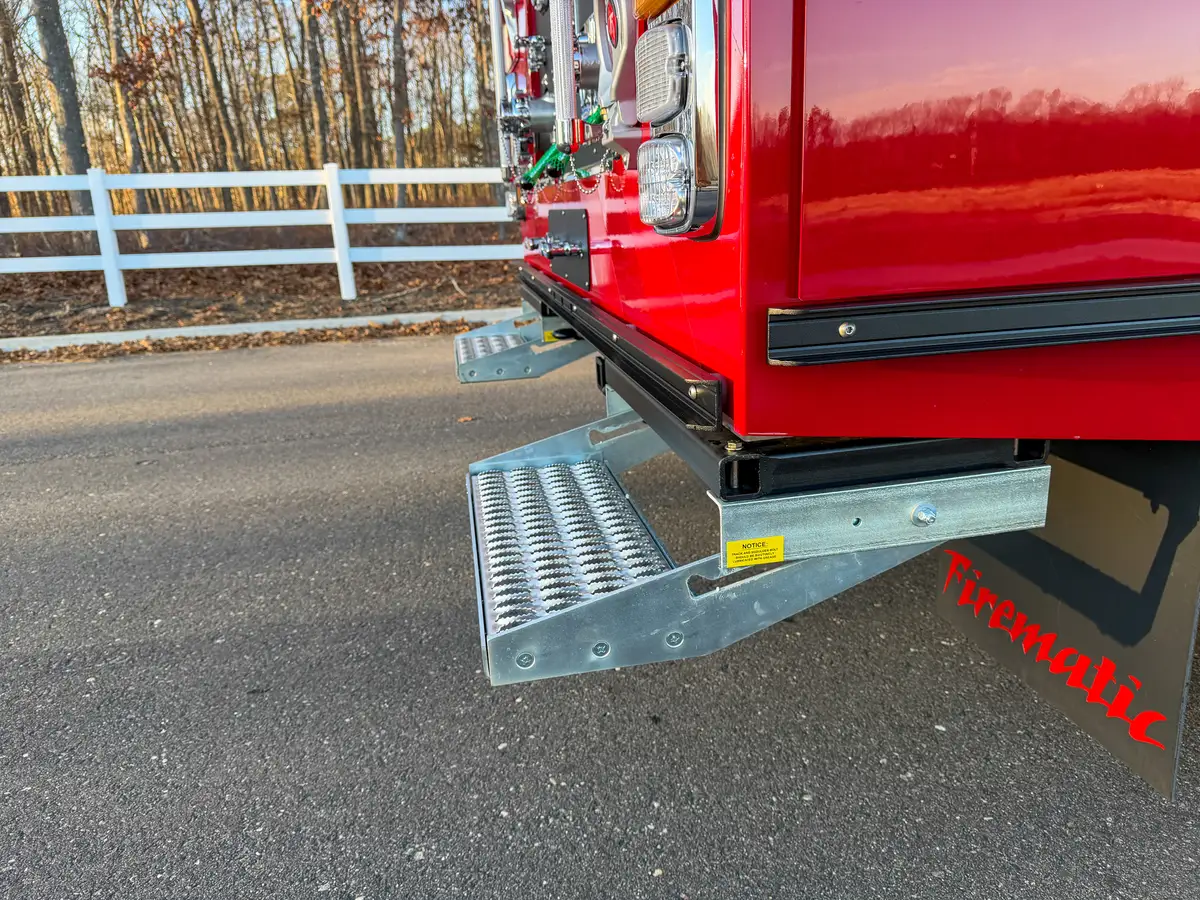 Side angle of deployed rear step and pump-panel corner.