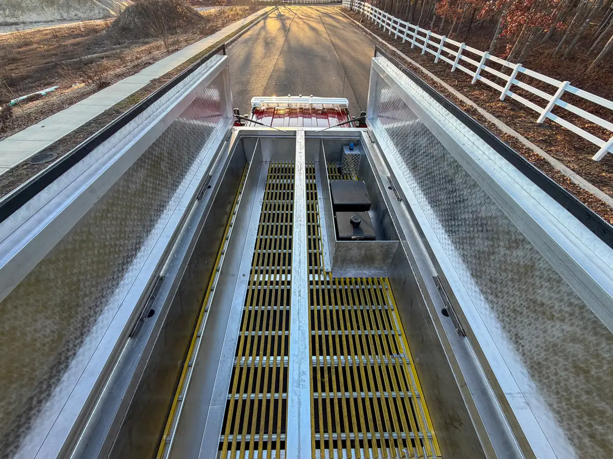 Top tank opening with both lids raised, showing grating and center divider.