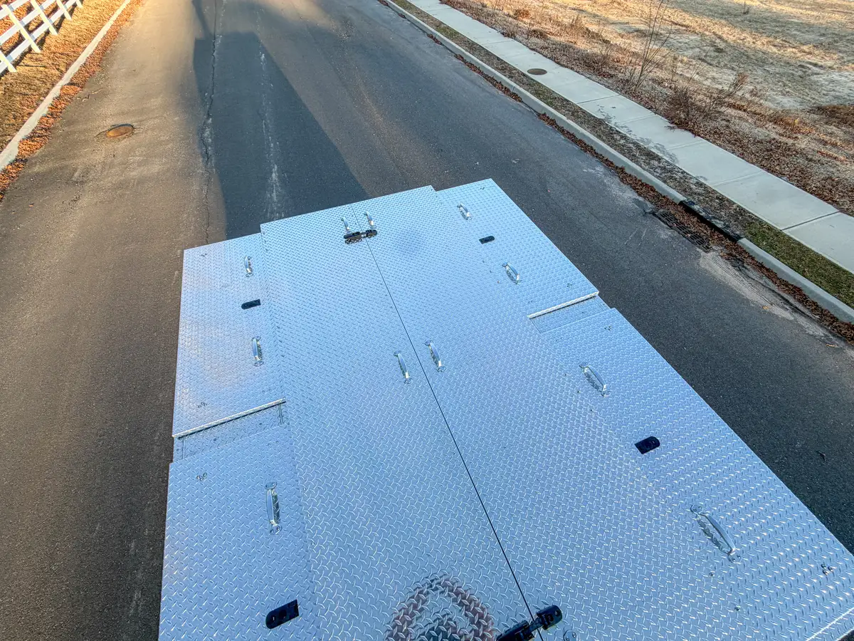 Overhead view of closed aluminum tread-plate rear deck lids.