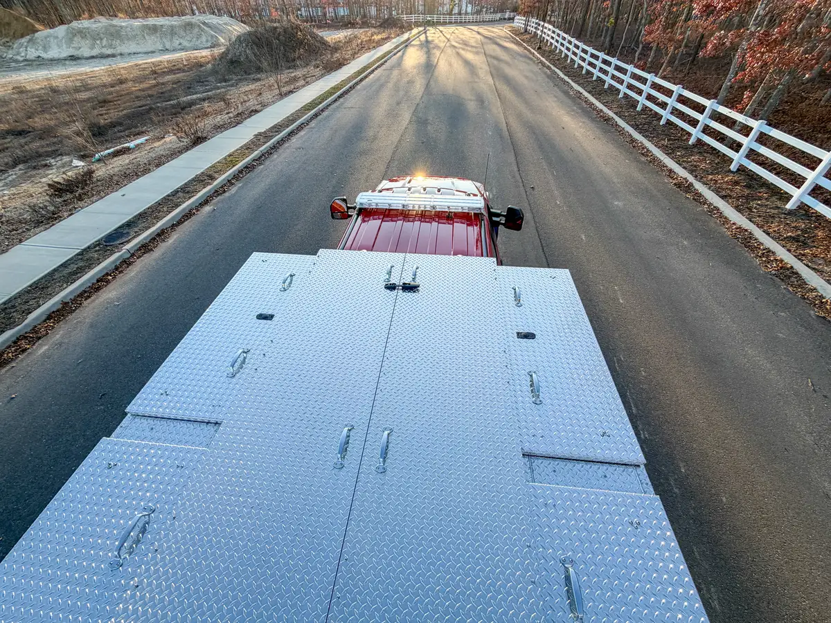 High rear-to-front view over the closed rear deck toward the cab roof.