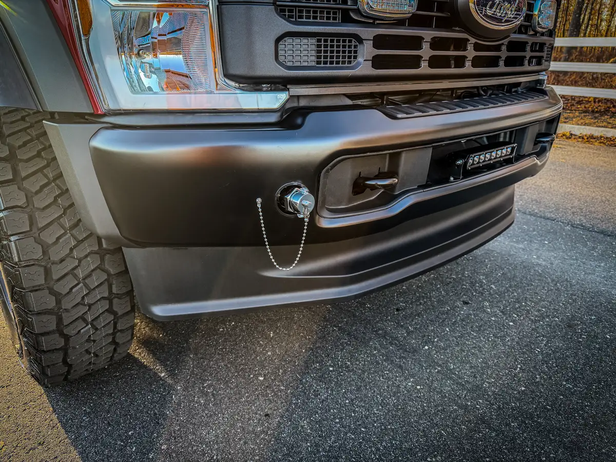 Close-up of front bumper corner with tow point and recessed light bar.