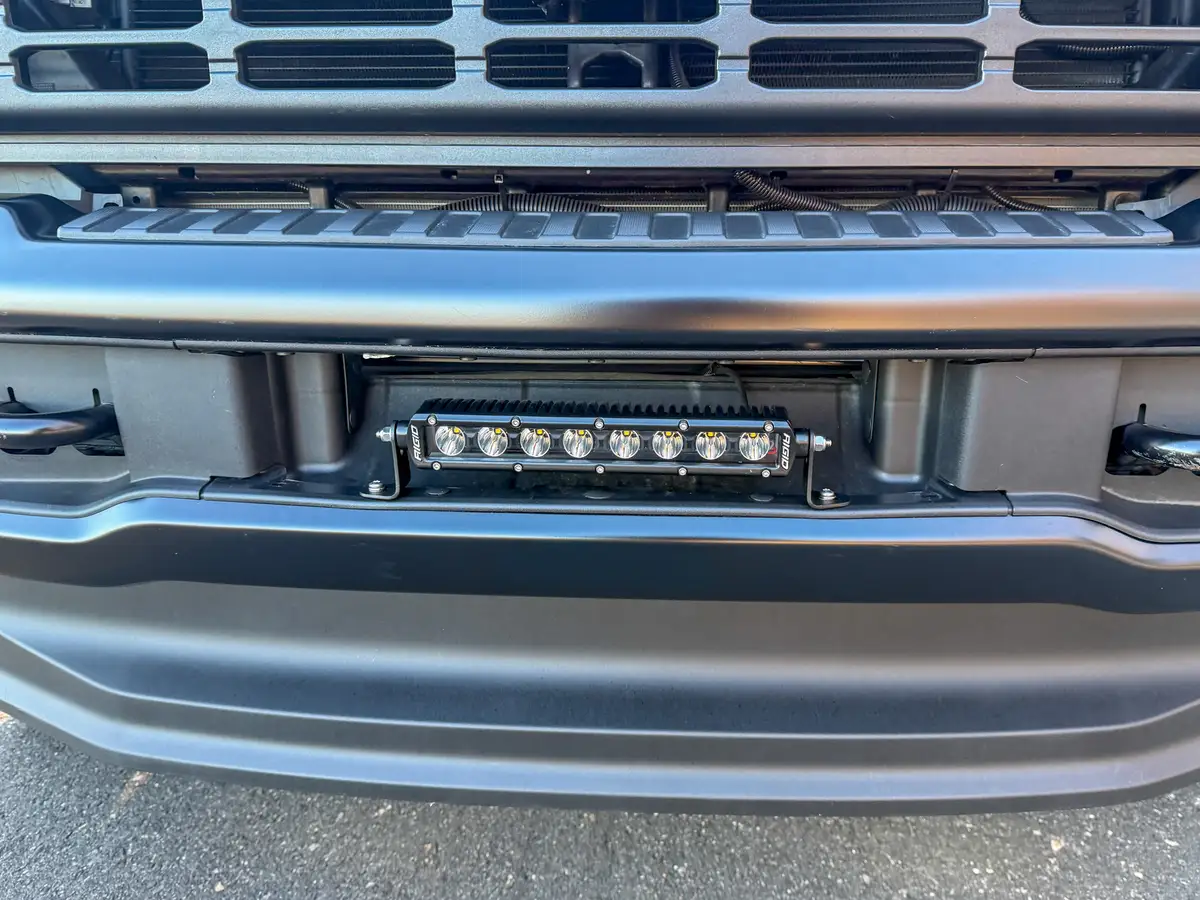 Close-up of recessed LED light bar mounted in the front bumper.