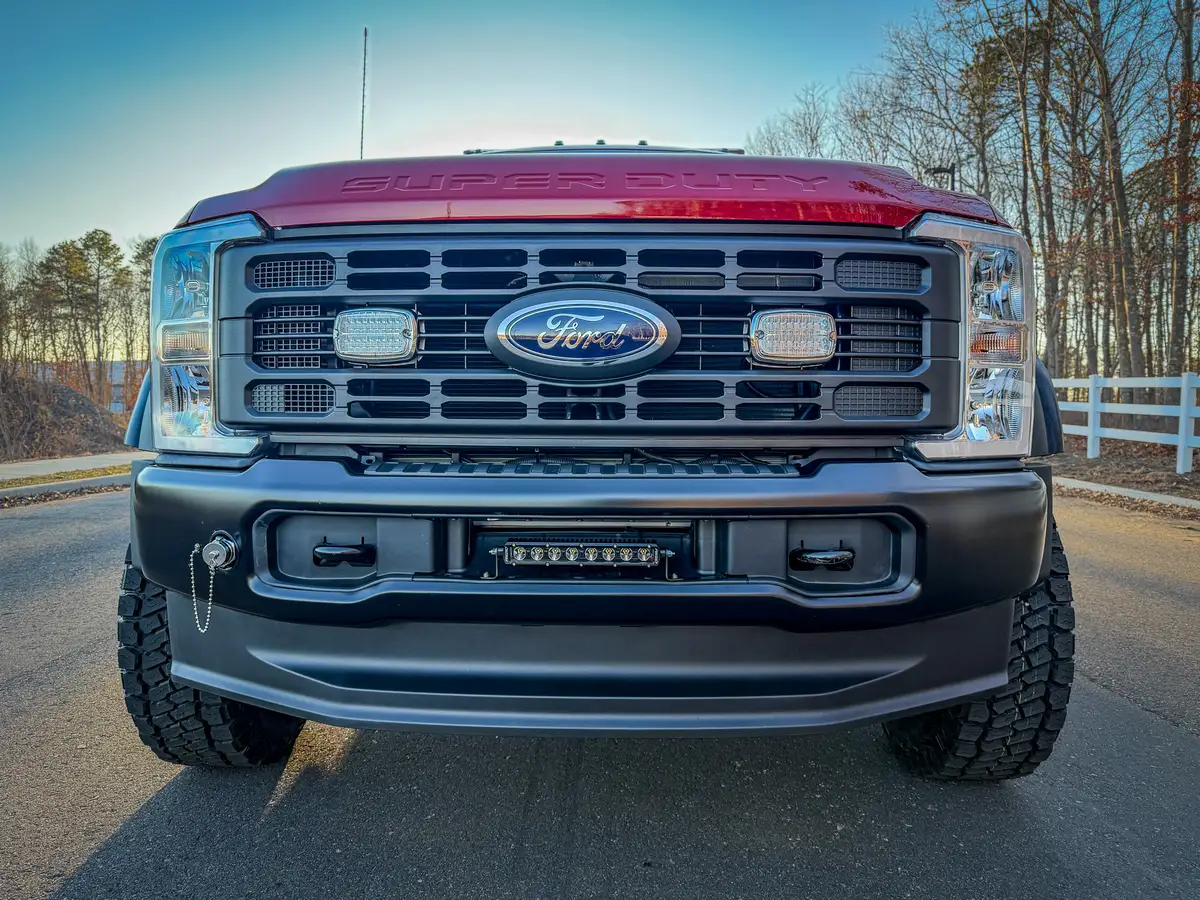 Head-on front view of grille, bumper, and oversized front tires.