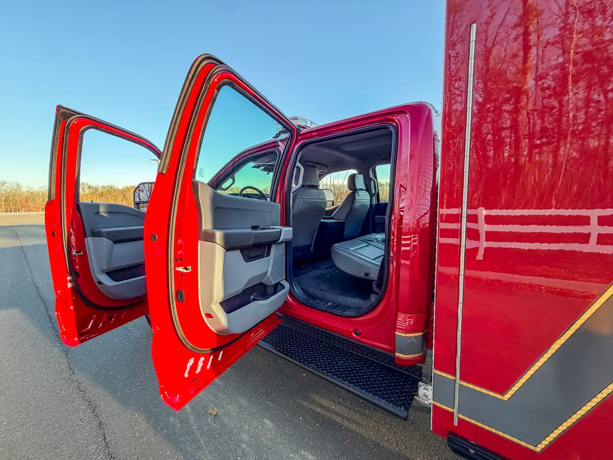 Side view with both front and rear passenger doors open to the cab.