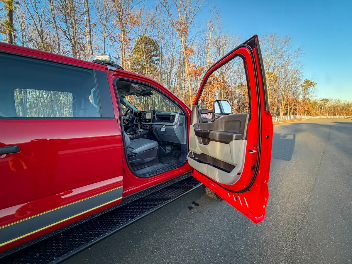 Passenger-side view with front door open showing seat and dashboard area.