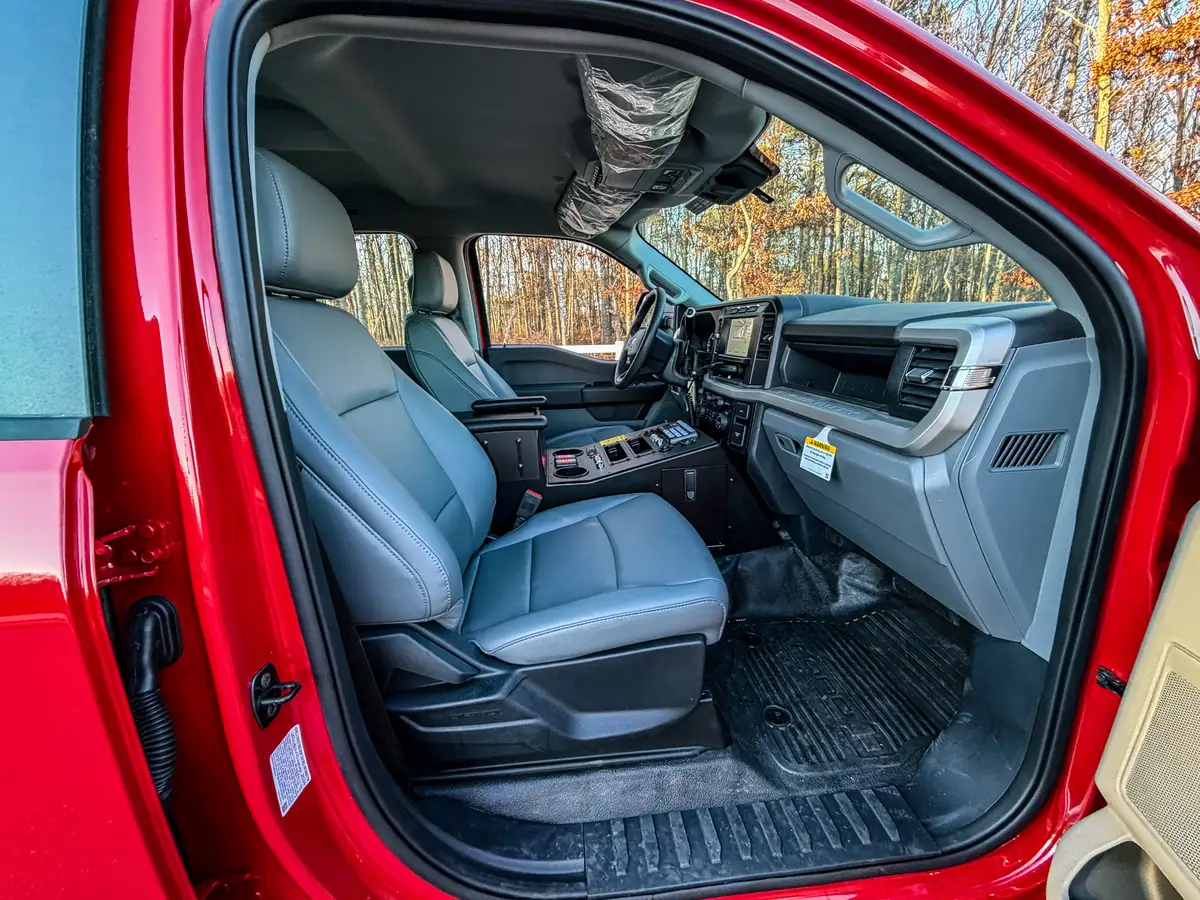 Passenger-side interior view with front seat, dashboard, and center console.