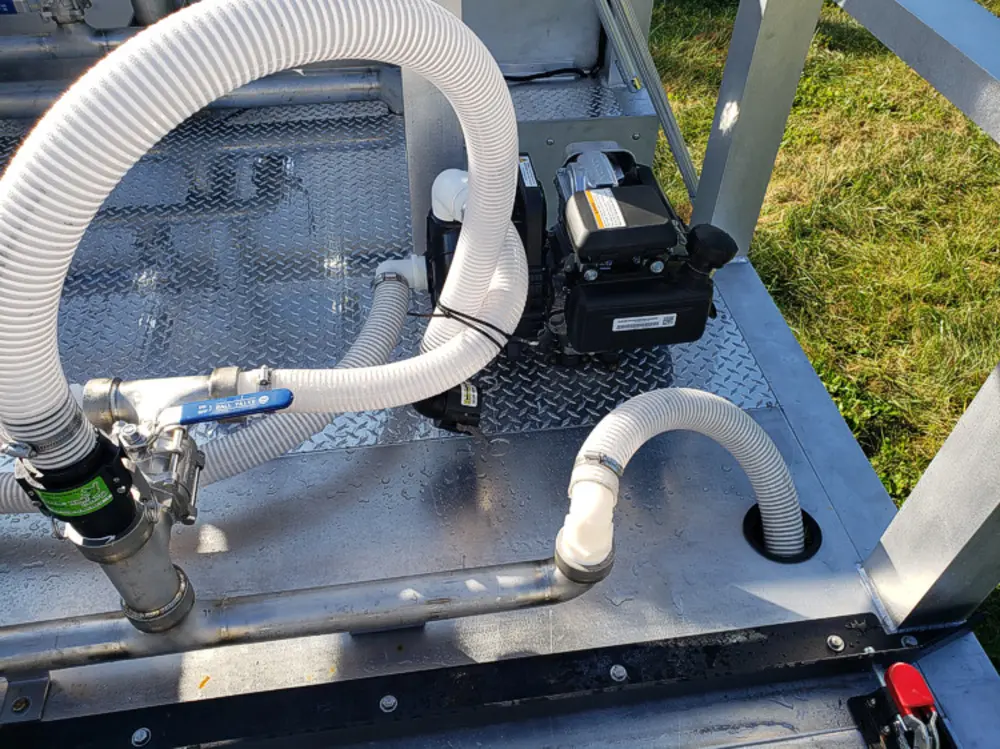 Exterior view of small fire truck showing cab, body compartments, and wheel/tire area.