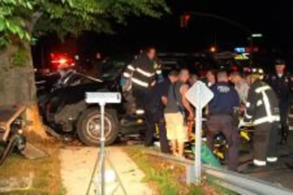 Exterior view of small fire truck showing cab, body compartments, and wheel/tire area.