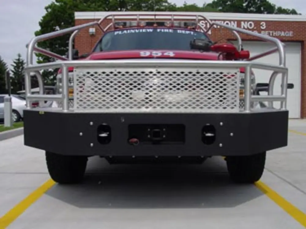Exterior view of small fire truck showing cab, body compartments, and wheel/tire area.