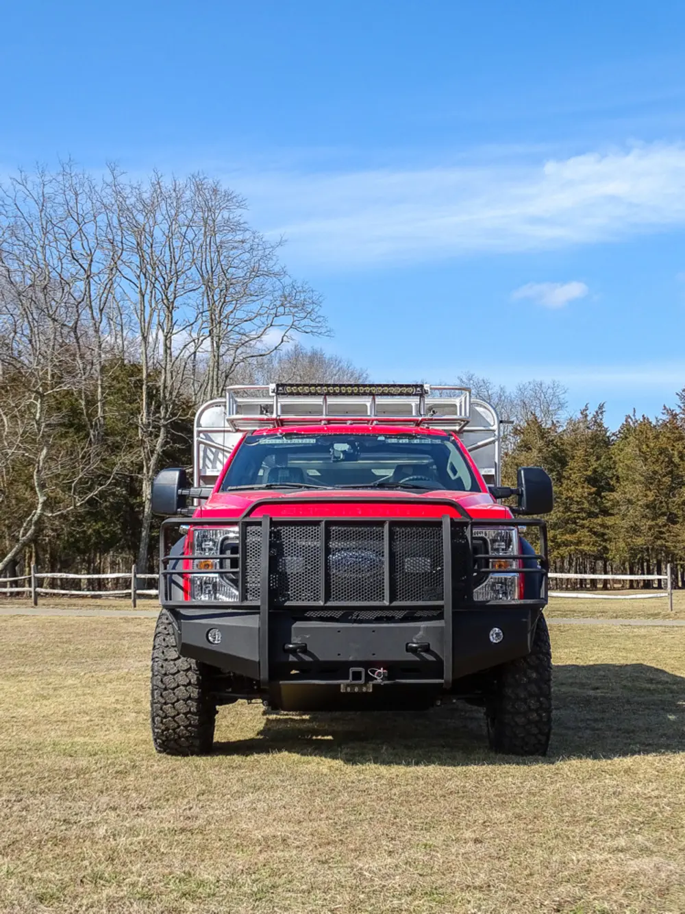 Exterior view of small fire truck showing cab, body compartments, and wheel/tire area.