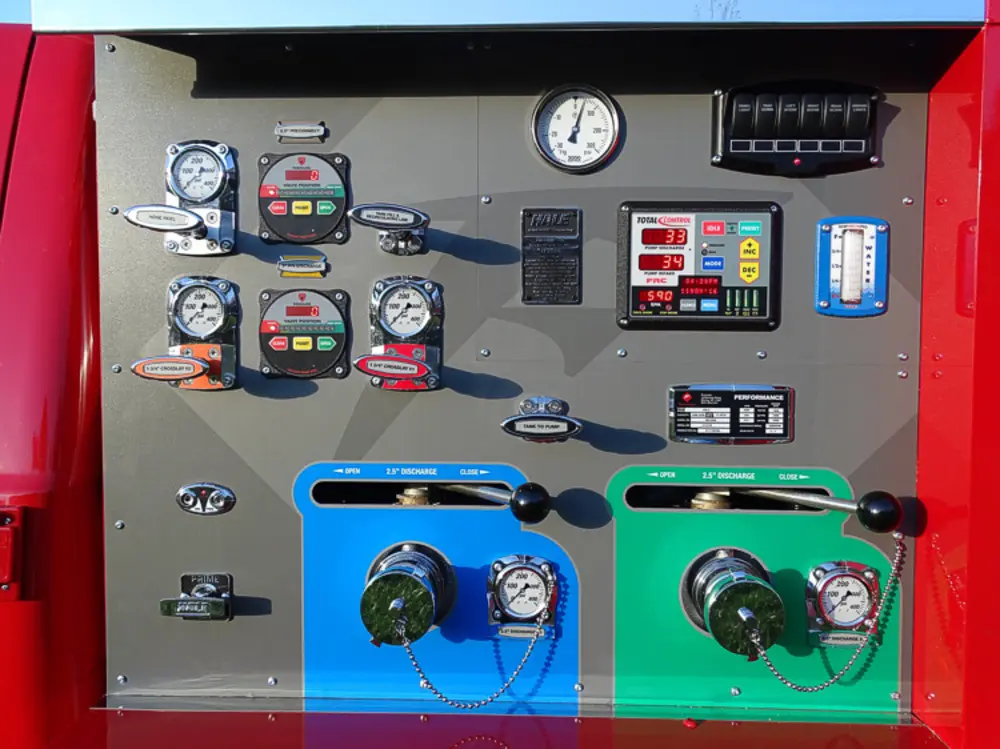 Exterior view of small fire truck showing cab, body compartments, and wheel/tire area.