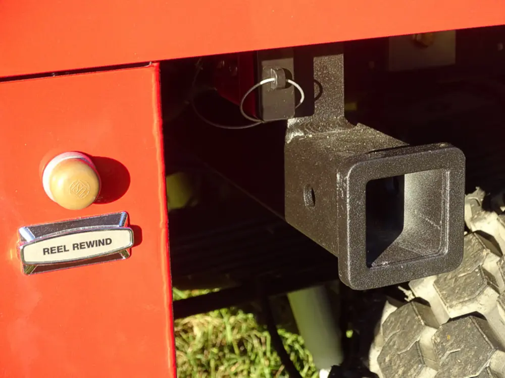 Exterior view of small fire truck showing cab, body compartments, and wheel/tire area.