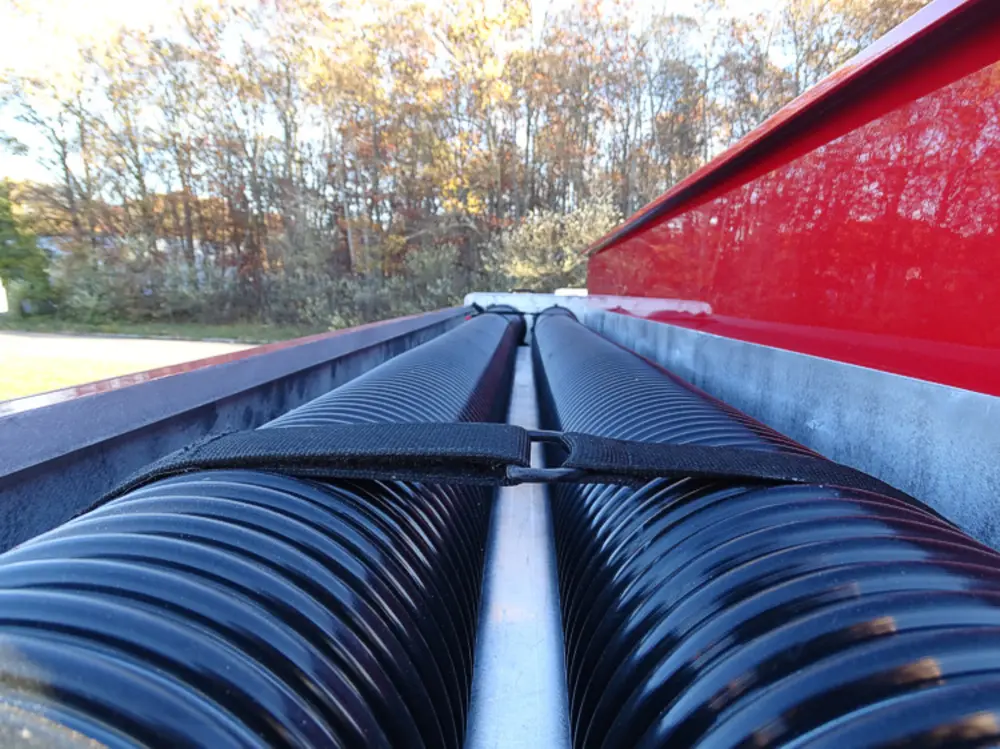 Exterior view of small fire truck showing cab, body compartments, and wheel/tire area.