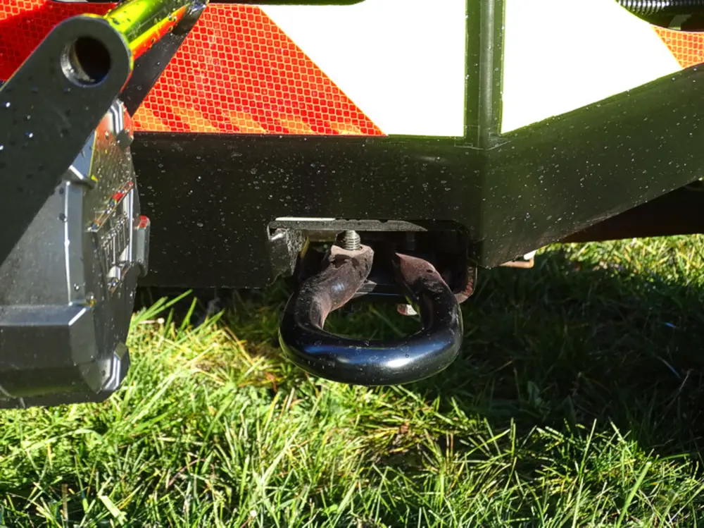 Exterior view of small fire truck showing cab, body compartments, and wheel/tire area.