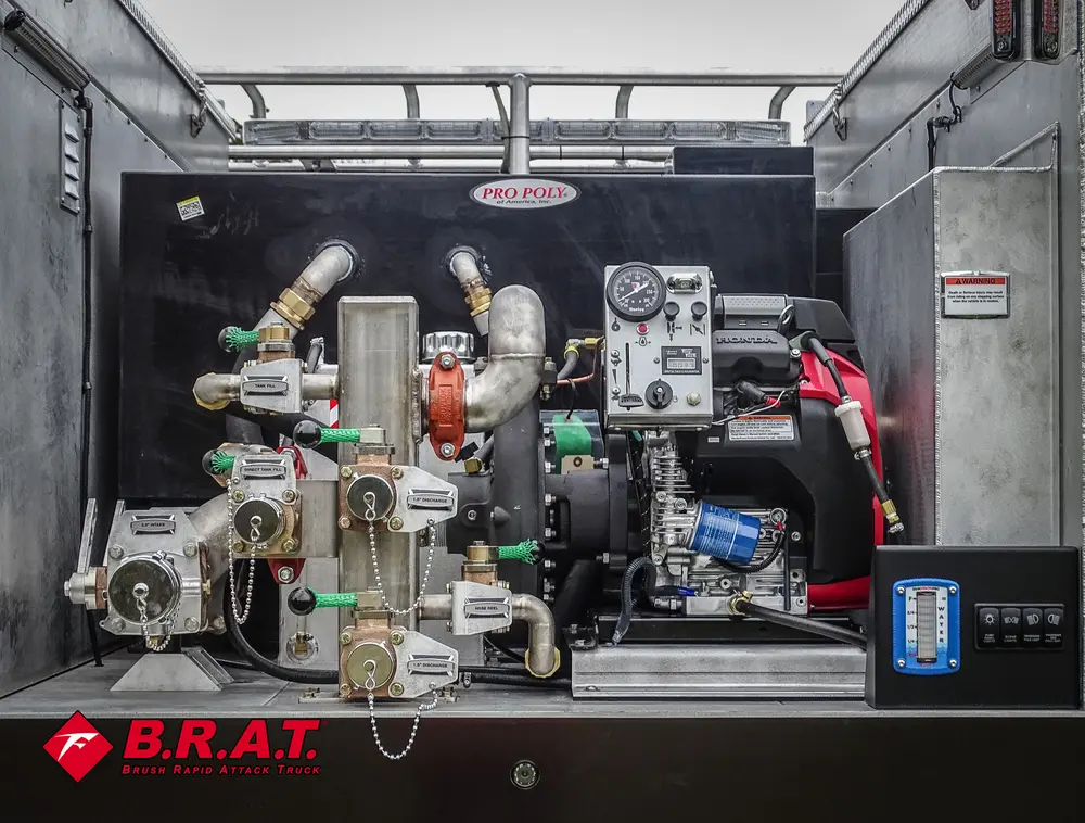 Exterior view of small fire truck showing cab, body compartments, and wheel/tire area.