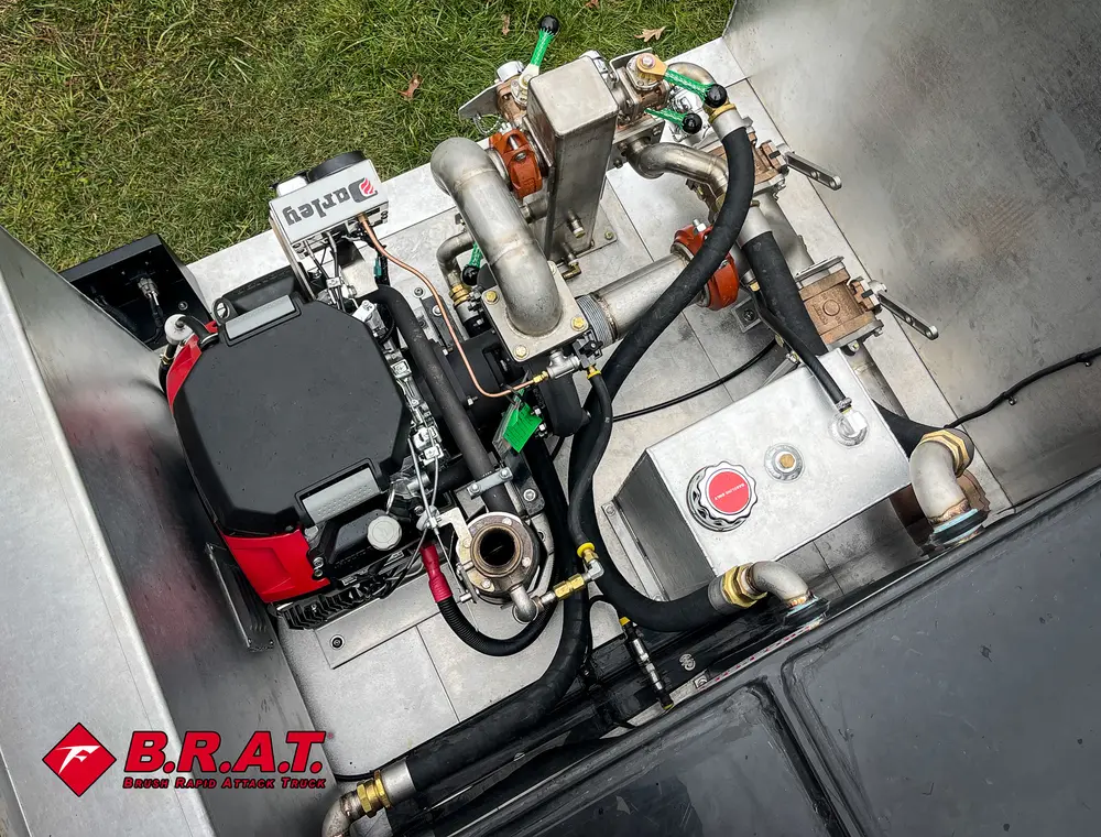 Exterior view of small fire truck showing cab, body compartments, and wheel/tire area.