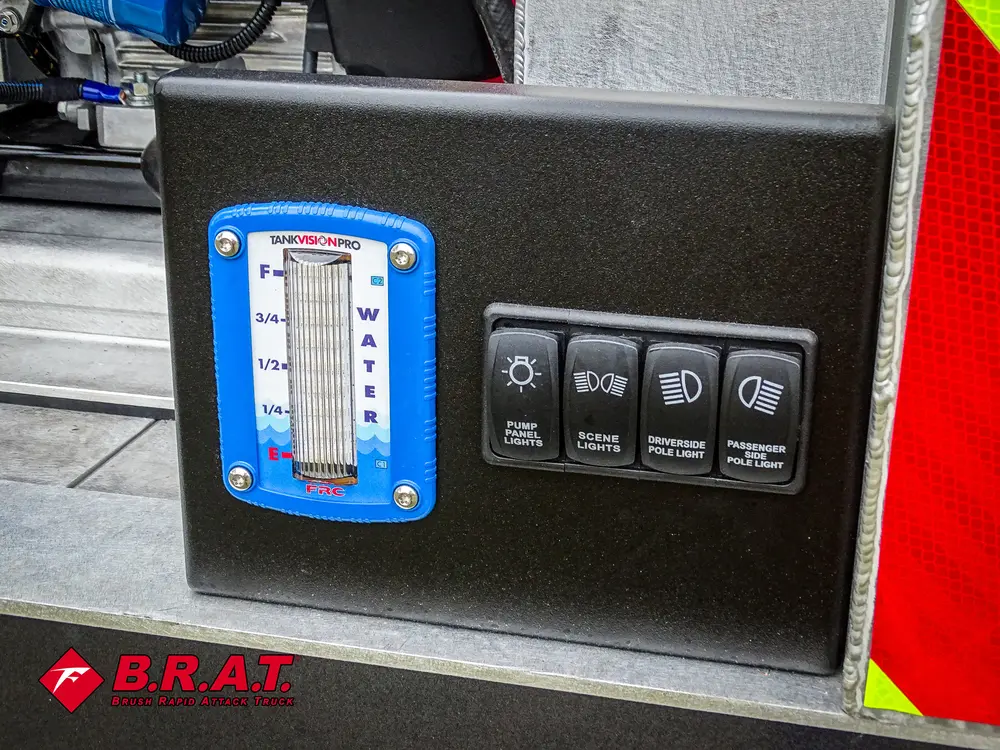 Exterior view of small fire truck showing cab, body compartments, and wheel/tire area.