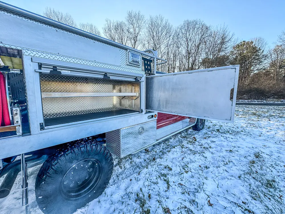 Long open side compartment with shelf and side door extended outward.