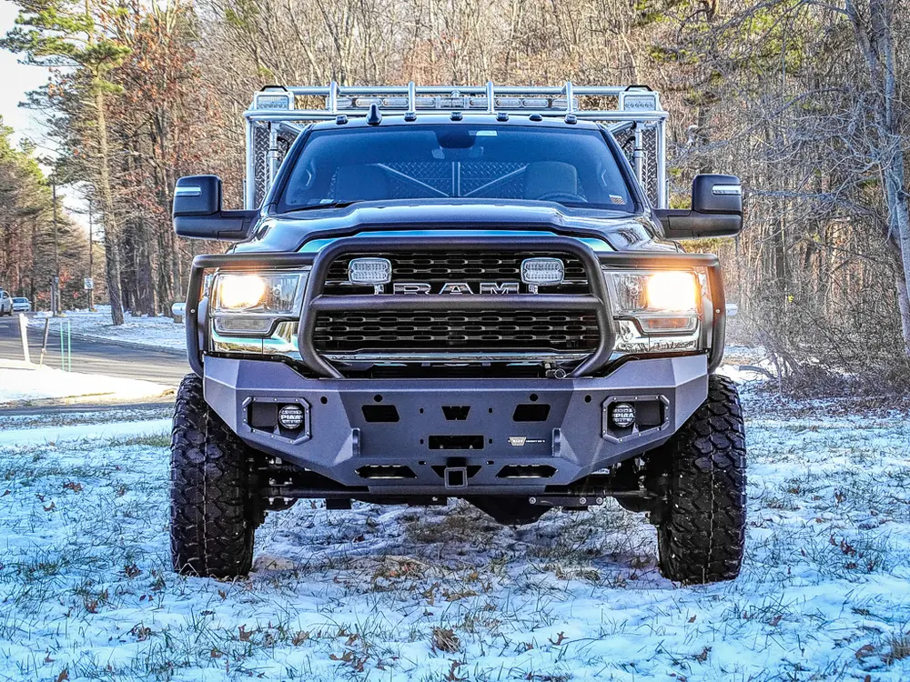 Head-on front view showing grille, bumper, and roof rack.