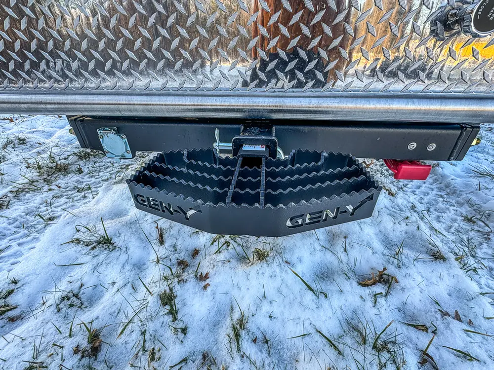 Rear underside view showing hitch receiver and mounted spare tire.
