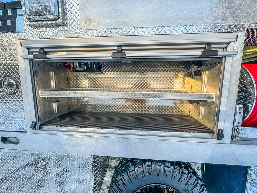 Open side storage compartment with shelf and empty interior.