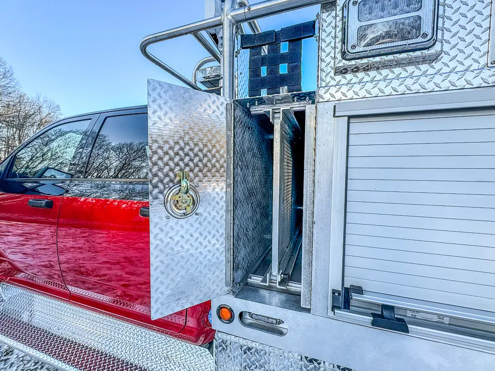 Vertical side compartment open, showing mounted mechanical hardware.