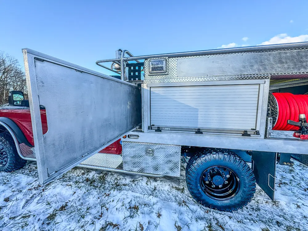 Side compartment view with outer door open and roll-up panel lowered.