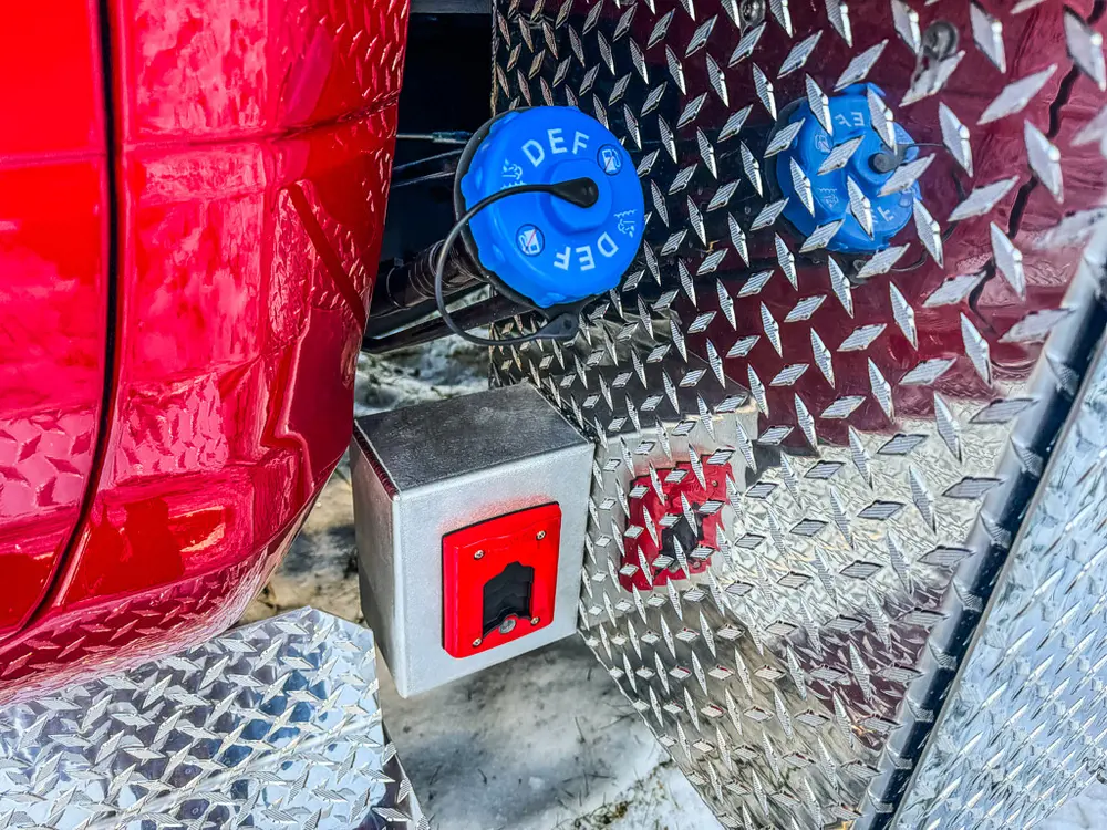 Close-up of body step area with DEF cap and exterior power outlet.