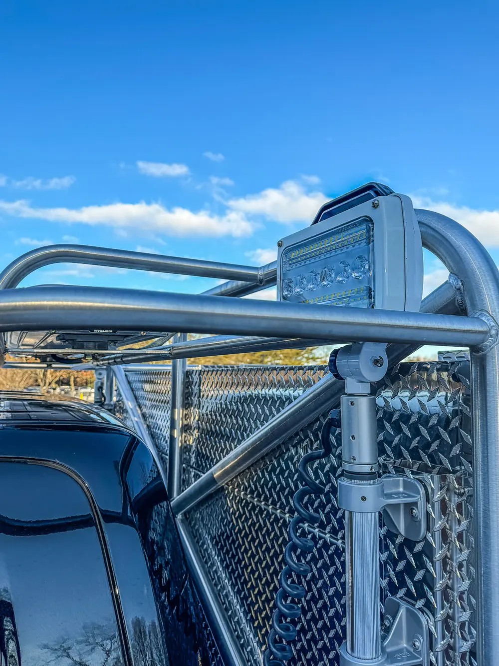 Close-up of upper body rail and mounted warning light assembly.