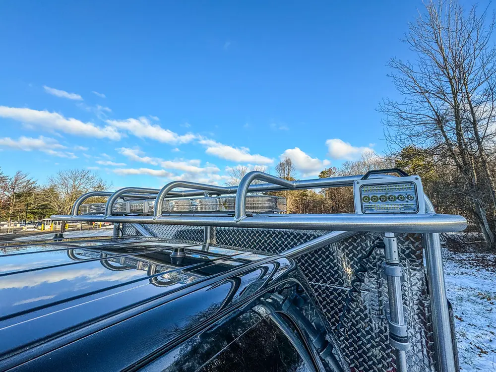 Top-deck view along the utility body rail and front warning light.