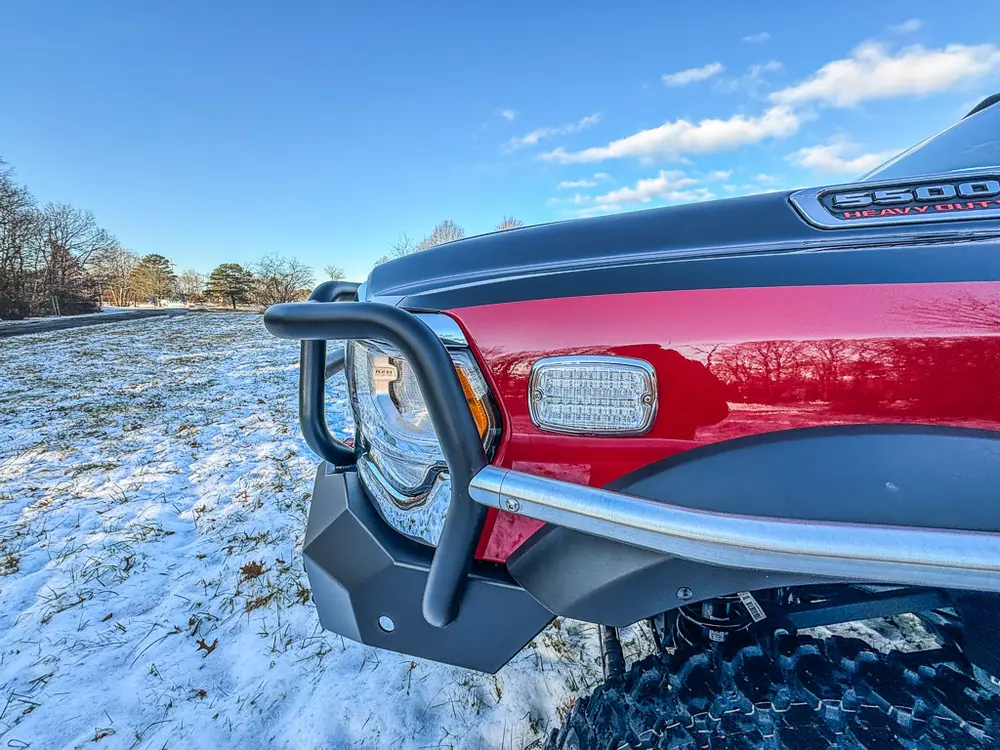 Front-left fender and brush-guard close-up near the headlight.