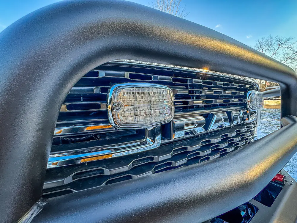 Front grille close-up with warning light mounted behind the brush guard.