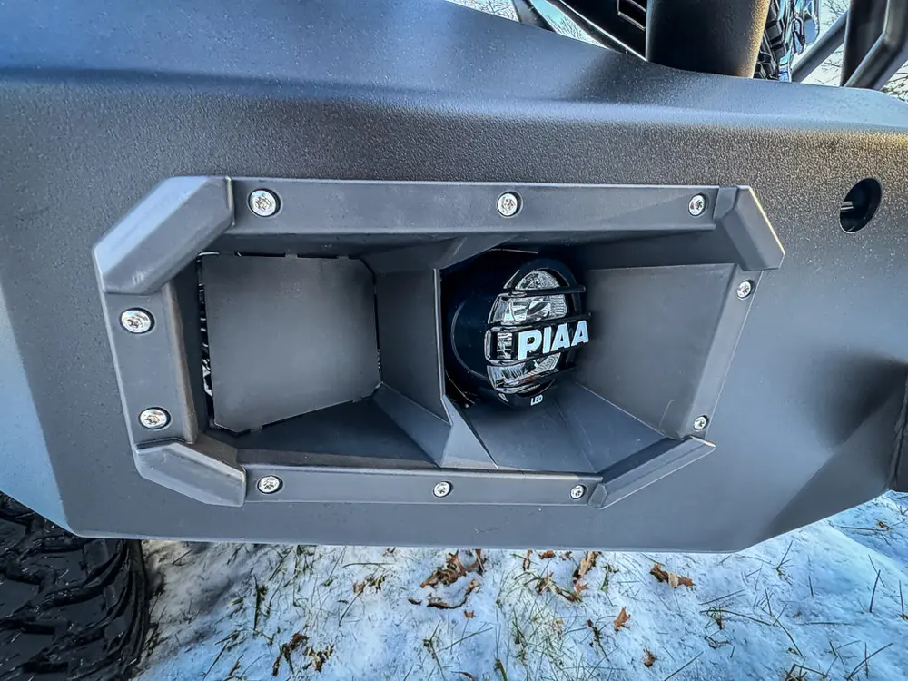 Close-up of rear bumper recess with mounted connection point and hardware.