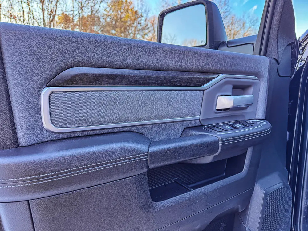 Interior close-up of the cab door panel and handle.