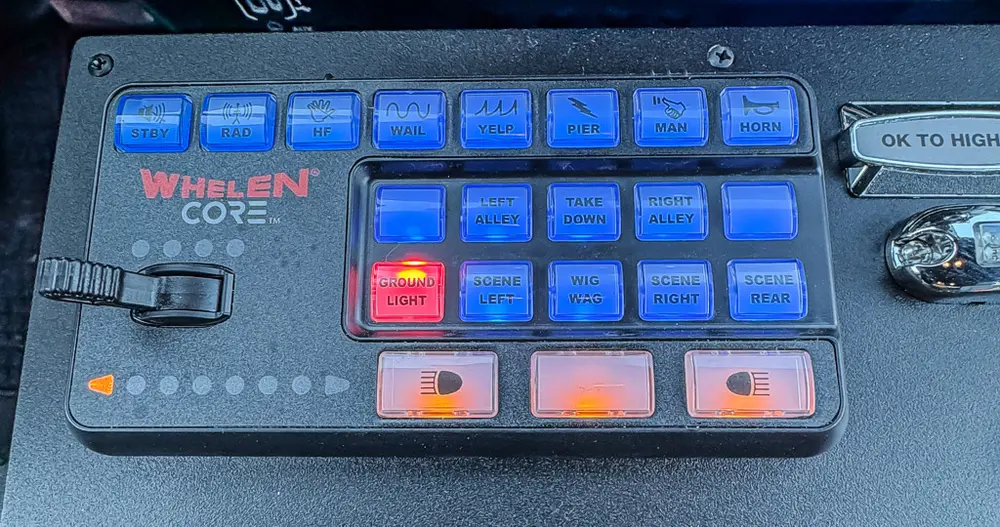 Close-up of Whelen control keypad and illuminated switch panel.