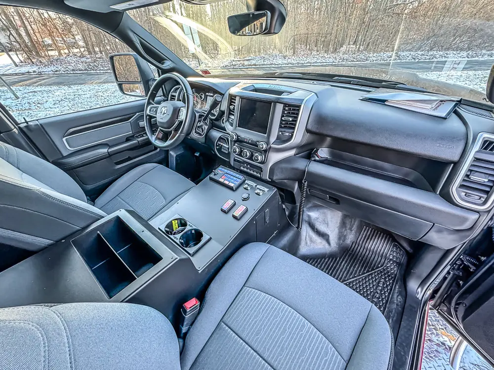 Angled front interior view showing center console, dashboard, and steering wheel.