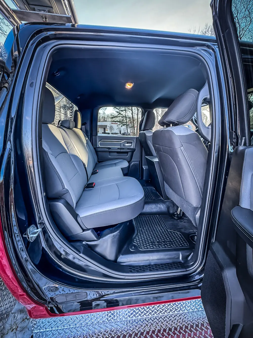 Rear passenger doorway view showing rear bench seat and cab floor area.