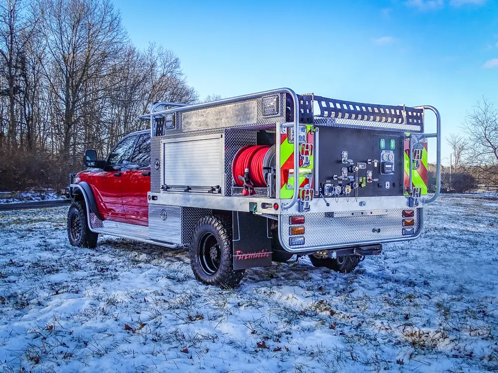 Rear-left three-quarter view with pump controls and rear compartment area visible.