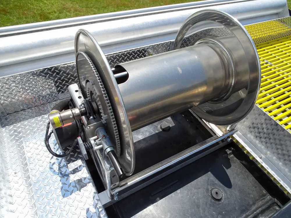 Exterior view of small fire truck showing cab, body compartments, and wheel/tire area.