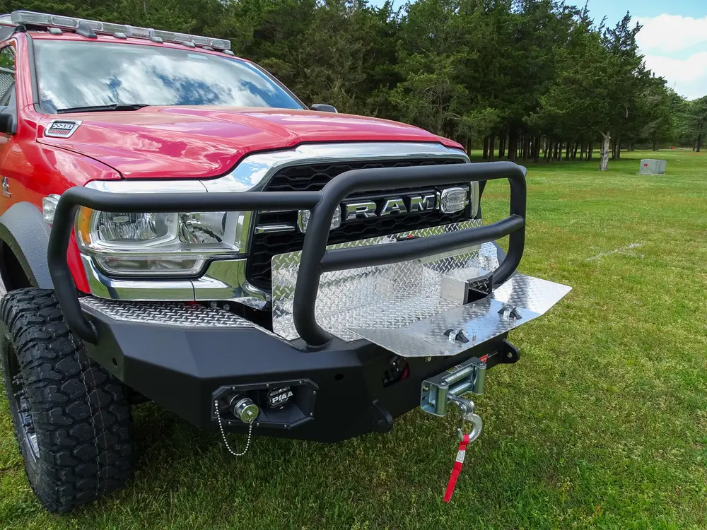 Exterior view of small fire truck showing cab, body compartments, and wheel/tire area.