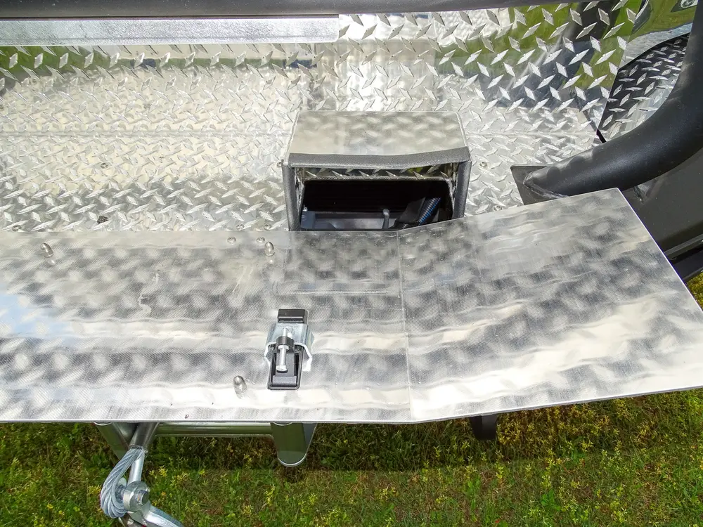 Exterior view of small fire truck showing cab, body compartments, and wheel/tire area.