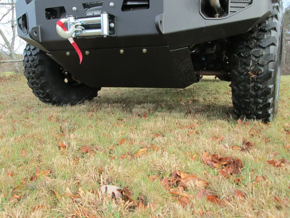 Exterior view of small fire truck showing cab, body compartments, and wheel/tire area.