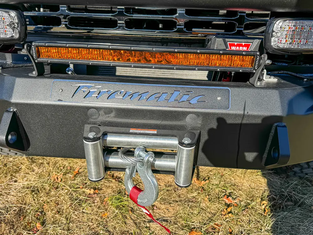 Lower front bumper close-up with winch fairlead and tow points.