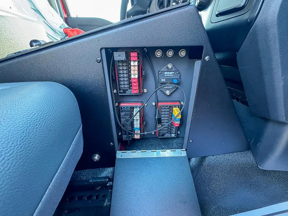 Passenger-side dash end close-up showing mounted electrical control panel.